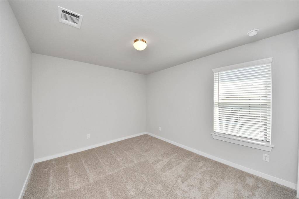 Generously sized secondary bedrooms featuring spacious closets, soft and inviting carpeting underfoot, large windows allowing plenty of natural light, and the added touch of privacy blinds for your personal retreat.