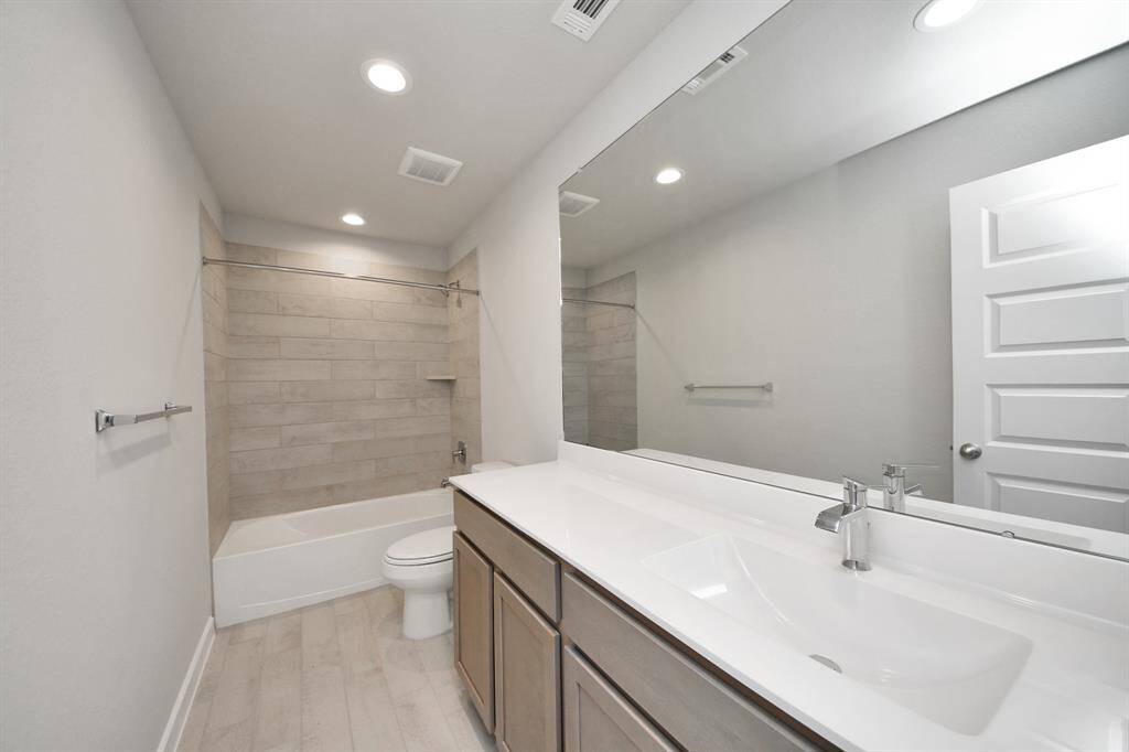 Secondary bedroom features plush carpeting, large windows that let in plenty of natural light, bright paint, and spacious closets.
