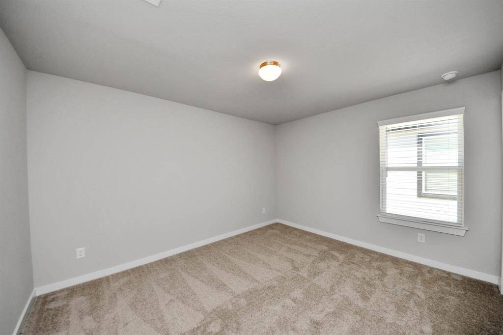 Generously sized secondary bedrooms featuring spacious closets, soft and inviting carpeting underfoot, large windows allowing plenty of natural light, and the added touch of privacy blinds for your personal retreat.