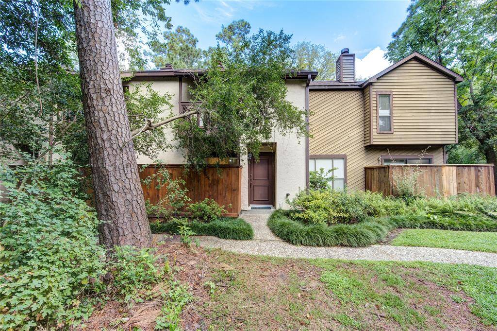 This two-story residence boasts tranquil views of the wooded area, ensuring privacy and a serene, quiet atmosphere, complemented by vibrant landscaping that enhances the natural beauty of the setting.