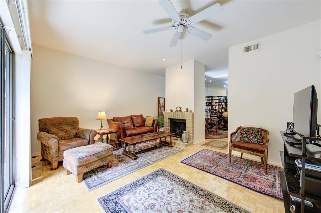 From the entrance door, you'll see the living room with a cozy fireplace seamlessly connecting to the breakfast/dining room, creating an inviting and open layout perfect for both relaxation and dining.