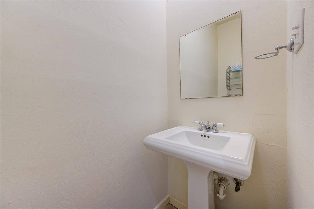 Conveniently located near the entrance, the first-floor half bathroom offers easy access and functional design for guests and everyday use.