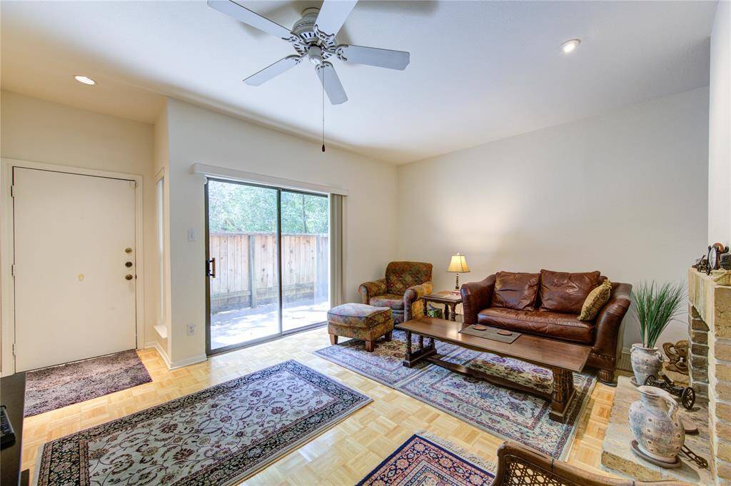 The first floor boasts a spacious living room with a cozy fireplace to the right, seamlessly extending to a charming large and fenced porch perfect for relaxing or entertaining, and features a convenient entrance door for easy access.
