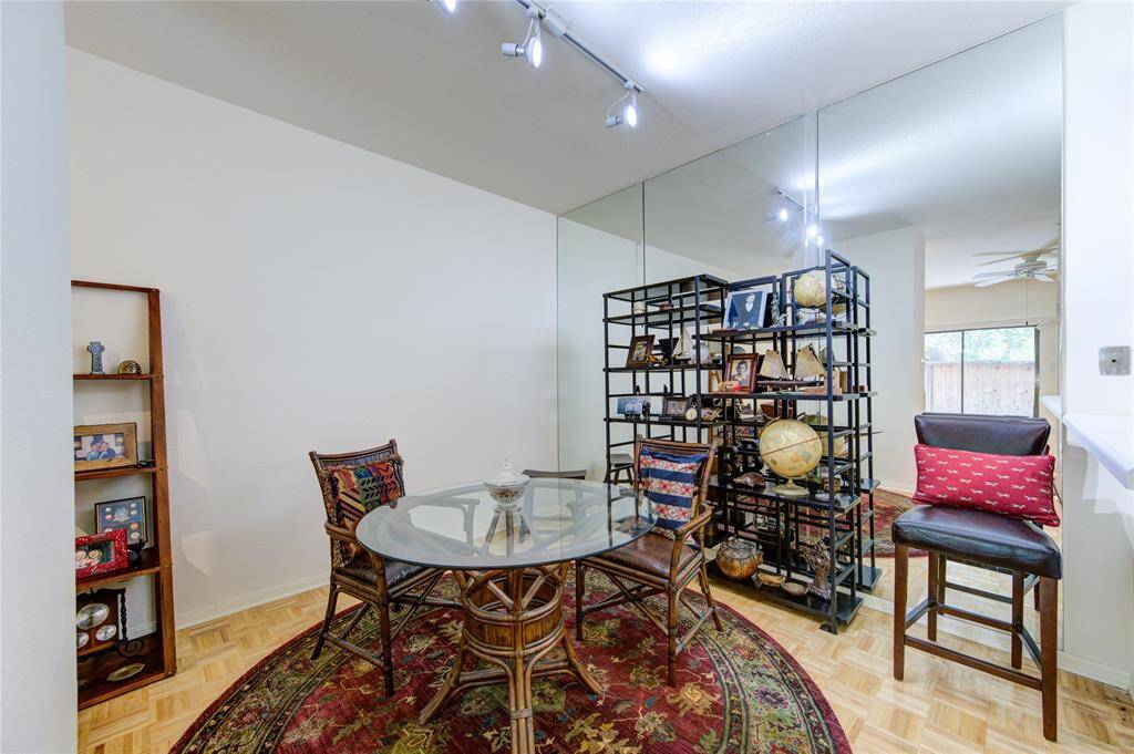The breakfast/dining room features a striking mirror wall, adding a touch of elegance and enhancing the room's sense of space and light.