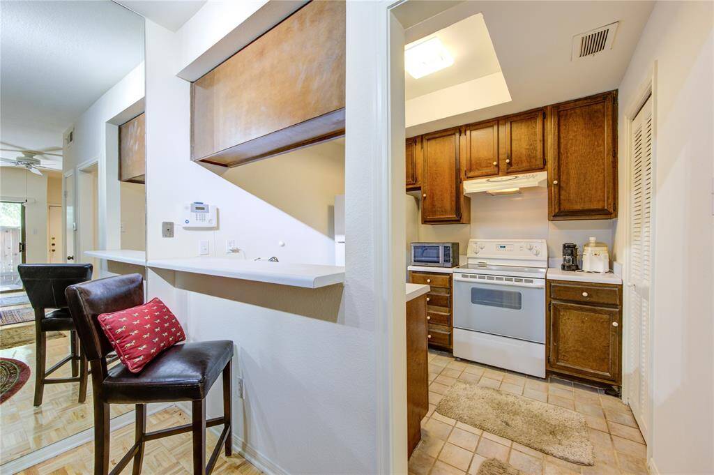 The kitchen on the first floor opens seamlessly to the breakfast/dining room on the left, with a walk-in pantry to the right, enhancing both functionality and convenience in this fluid, interactive space.