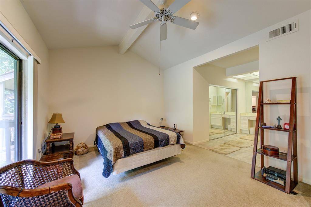 On the second floor, the primary bedroom serves as a serene retreat with a vaulted ceiling and direct access to a spacious walk-in closet featuring built-in mirrors. The conveniently positioned primary bathroom is located to the left, enhancing both comfort and functionality.