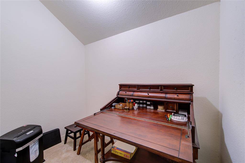The second floor features a well-appointed home office connected to the primary bedroom, with a window overlooking the deck that floods the space with natural light, providing an ideal environment for work or study.