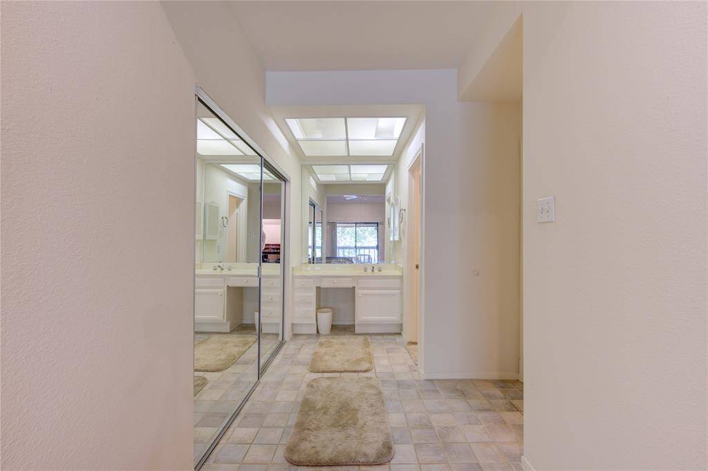 On the second floor, the primary bedroom offers a walk-in closet to the right, vanity in the center and primary bathroom conveniently located to the left, providing a well-organized and functional living space.