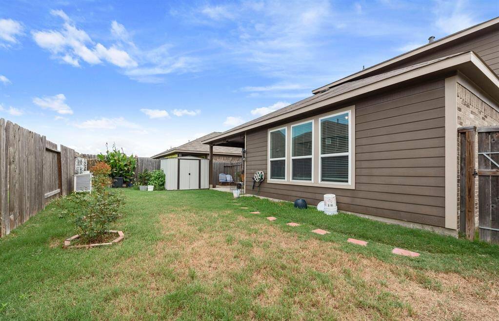 Here is another view of the backyard with a shed for the lawn equipment.