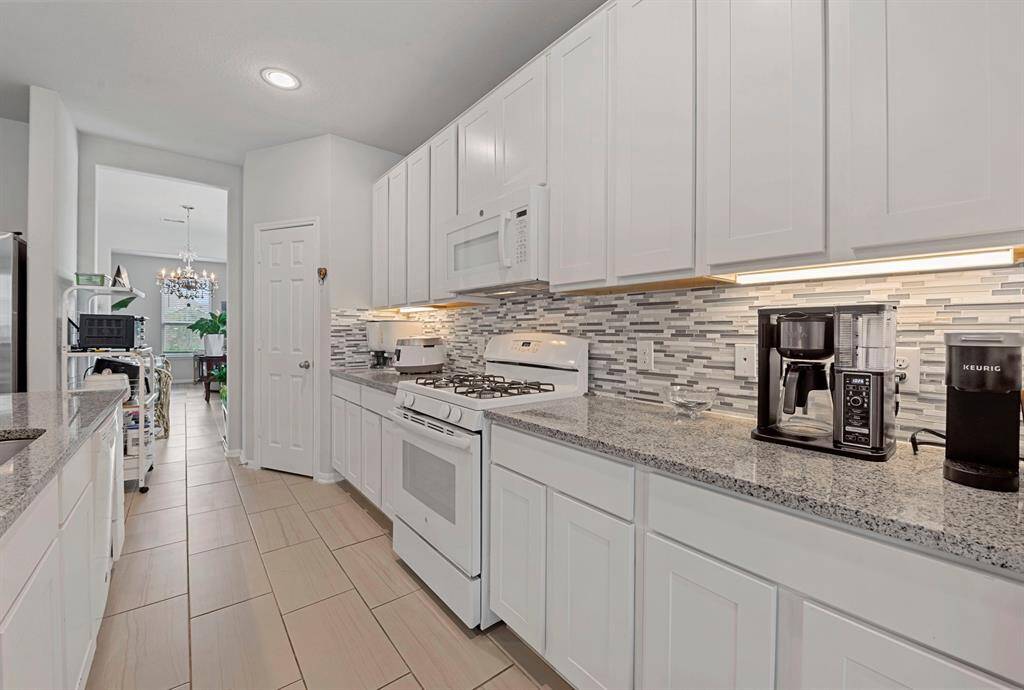 Beautiful granite counter tops with accent tile backsplash. Large pantry and several cabinet that will help you whip up all of the dishes your family loves and appreciates.