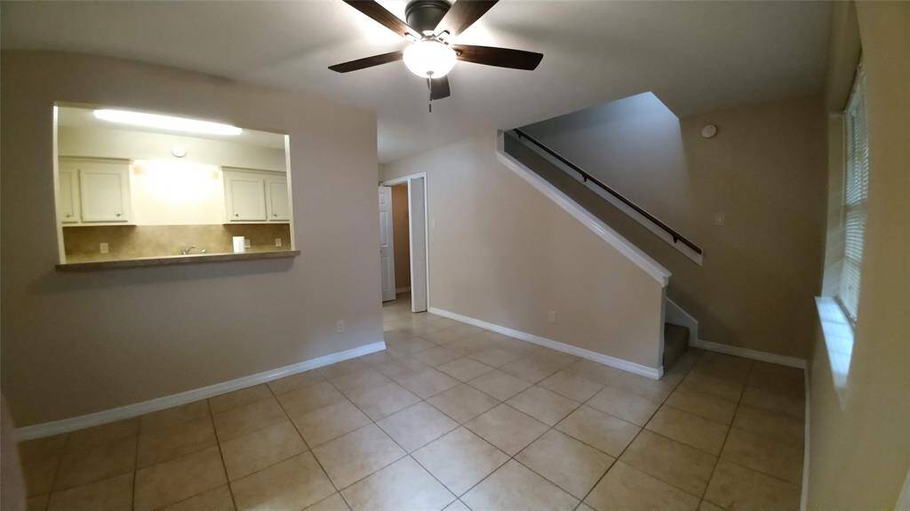 Right of the entry way, you see the breakfast bar, the dining area, washer/dryer utility closet, stairs, and exterior window.