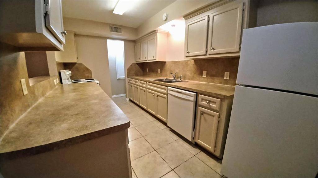 A spacious kitchen with plenty of counter space and storage options including a convenient pass-through shelf to the dining area. Equipped with an electric range, dishwasher, and refrigerator for ultimate cooking convenience.  And don't forget the handy pantry for all your organizational needs.