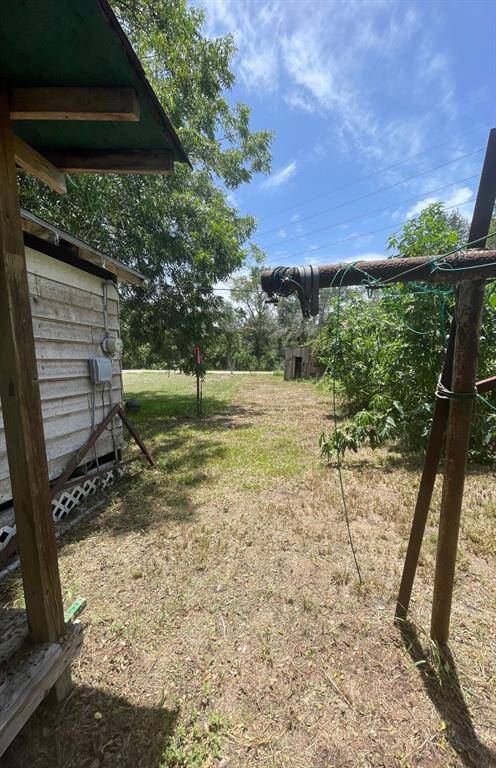 Back yard of 1 story house. looking at Wallis Street