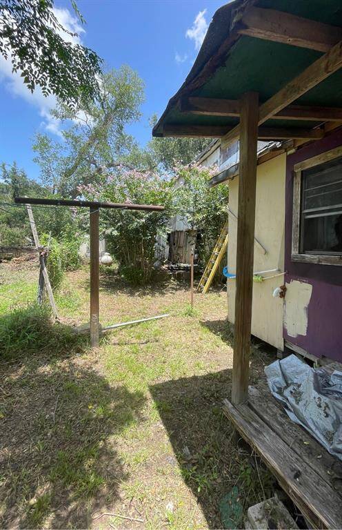 back yard of 1 story house looking towards 2 story back yard.