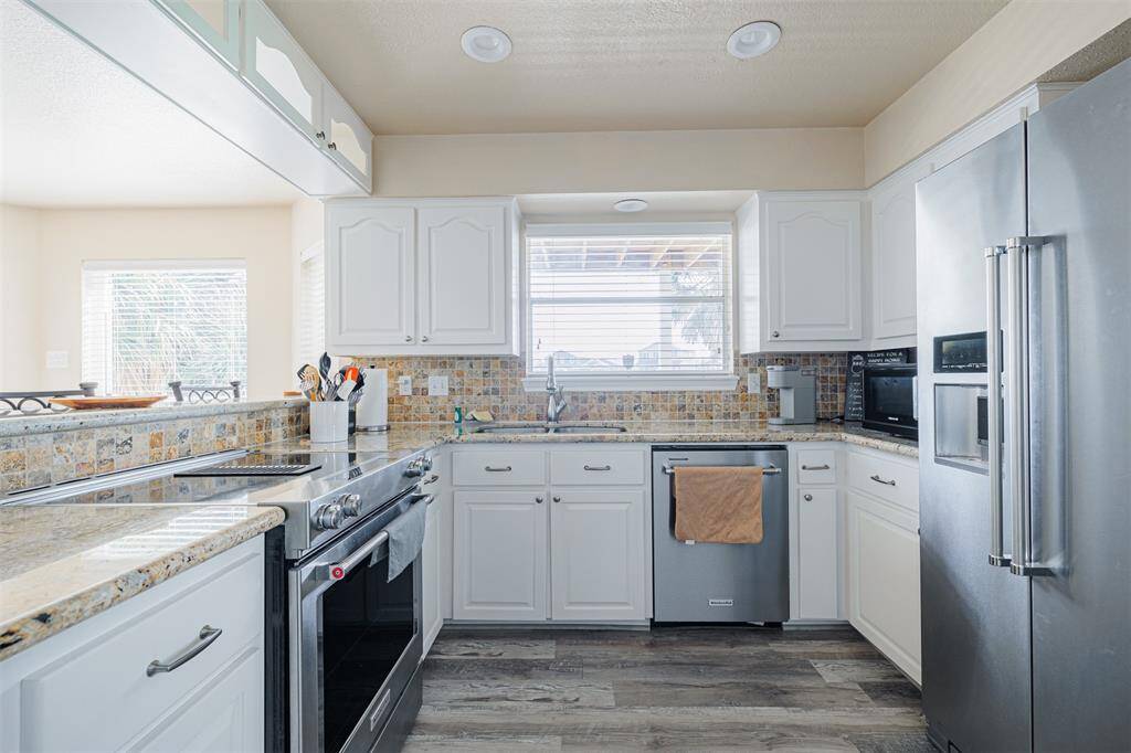 As you walk into the house, the light and spacious kitchen is in front of view