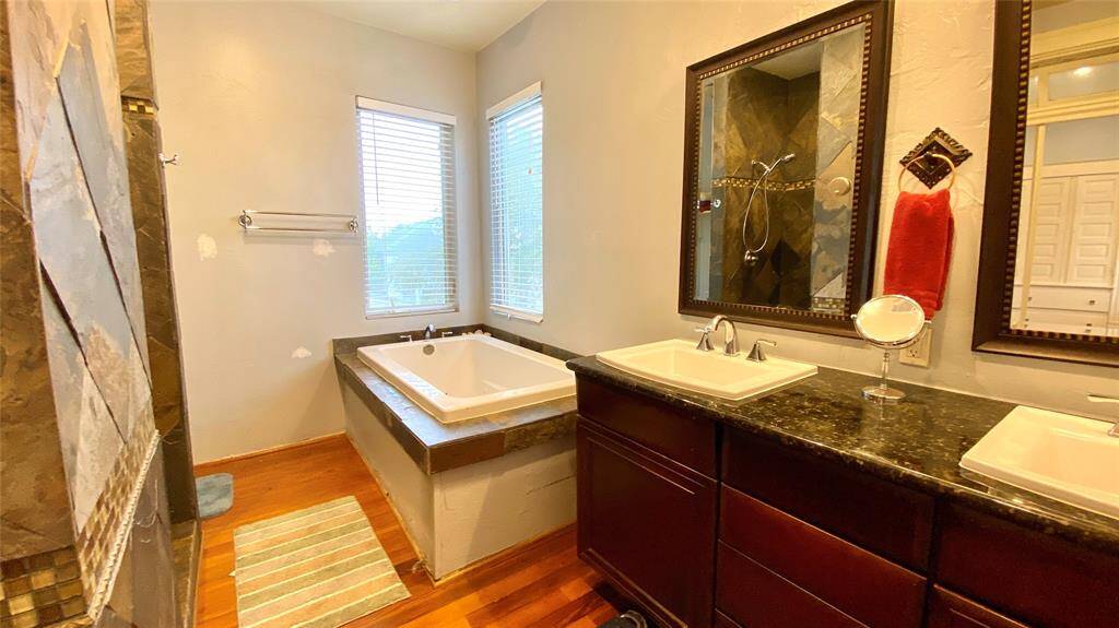 Primary en-suite has an oversized soaking tub with a separate shower