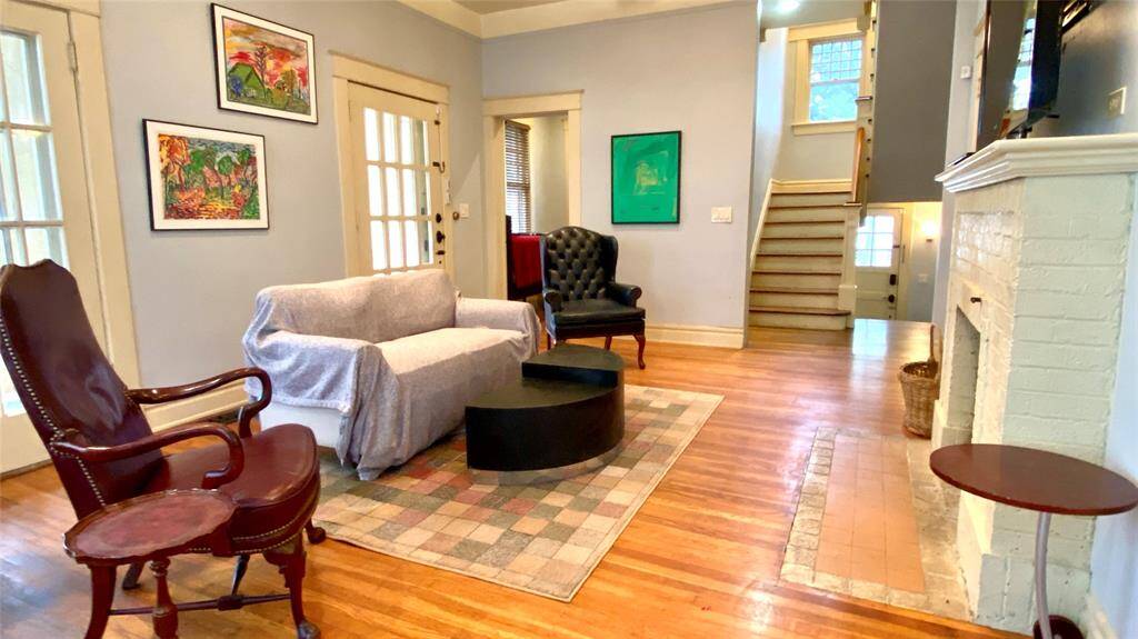 Spacious living room has wonderful French doors leading to the front porch and includes a fireplace
