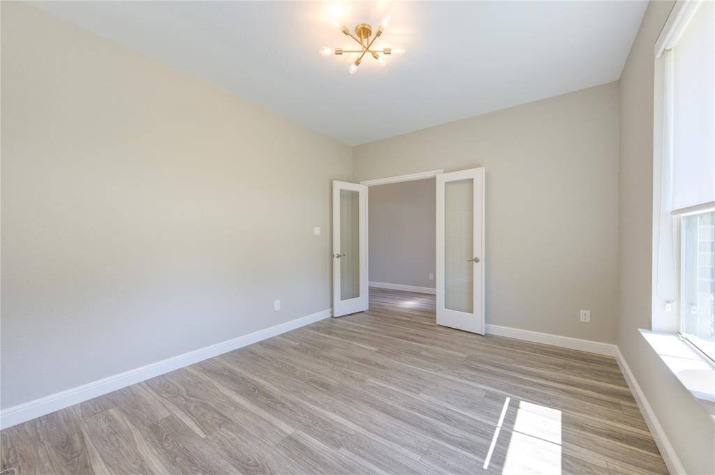 Office with updated light fixture and French doors.