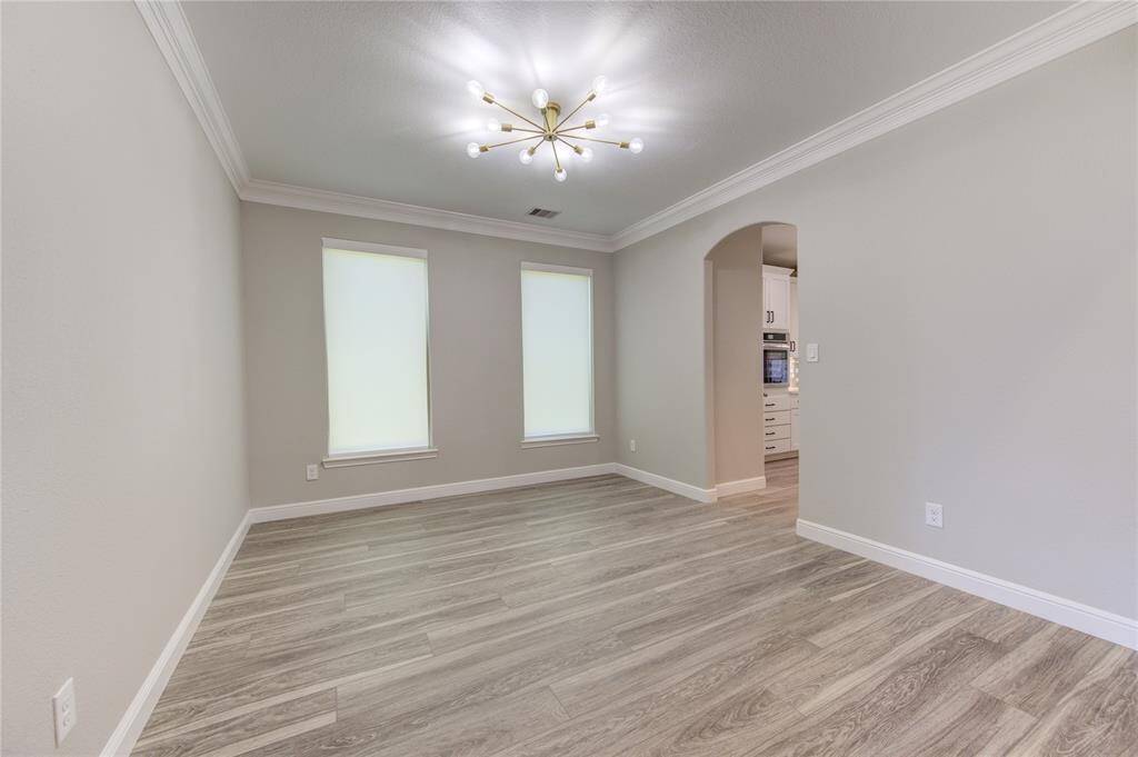Formal dining room updated lighting matching the office/breakfast area.