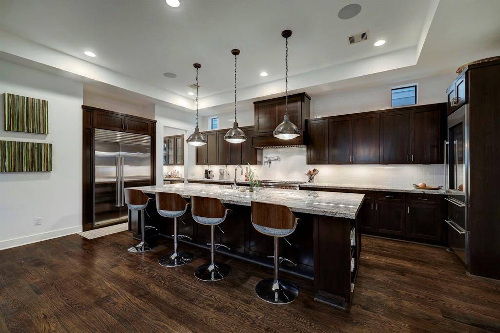 Well planned 278 bottle wine room with frameless glass doors, conveniently located off kitchen.