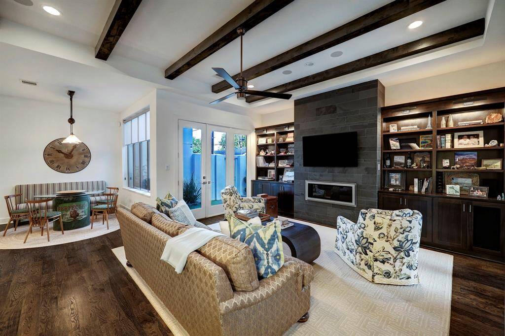 Family room has doors to pool/patio. great built ins and storage below. 5.1 surround sound wiring on ceiling.
