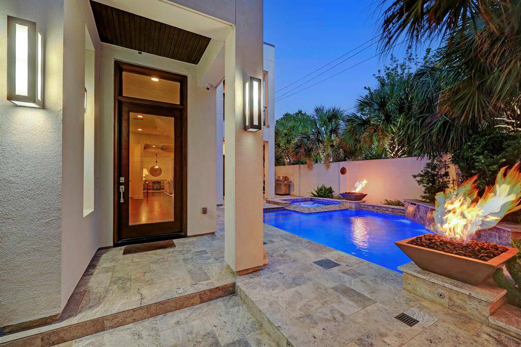 Handsome exterior elevation with privacy wall on corner lot with abundant natural light.