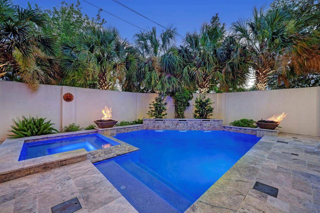 Covered patio just off family room, perfect space for your grill as shown. A very fun place to watch sports events and enjoy the outdoors.Festive string lights and 6 hole putting green just beyond.