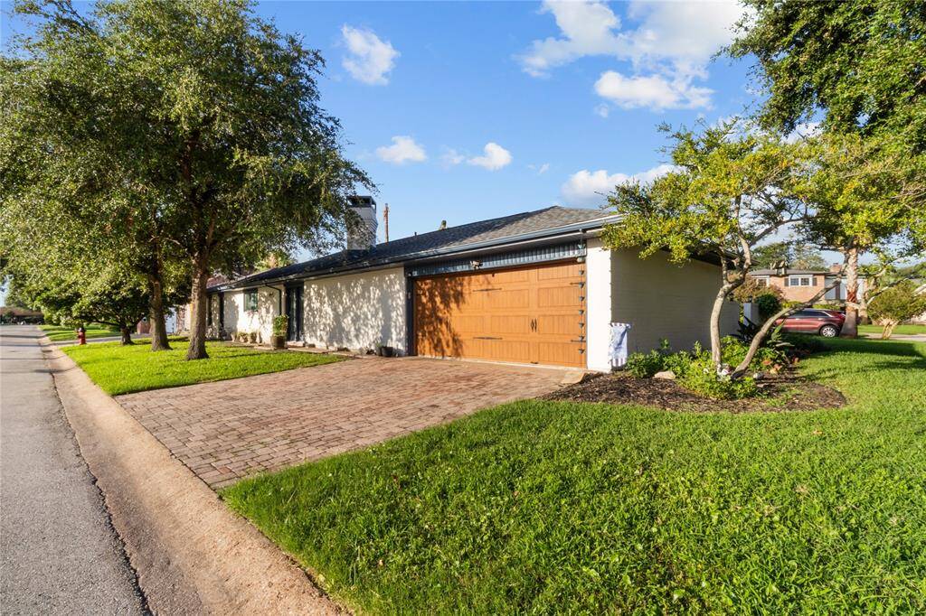 Brick pavers provide a decorative entry to garage.