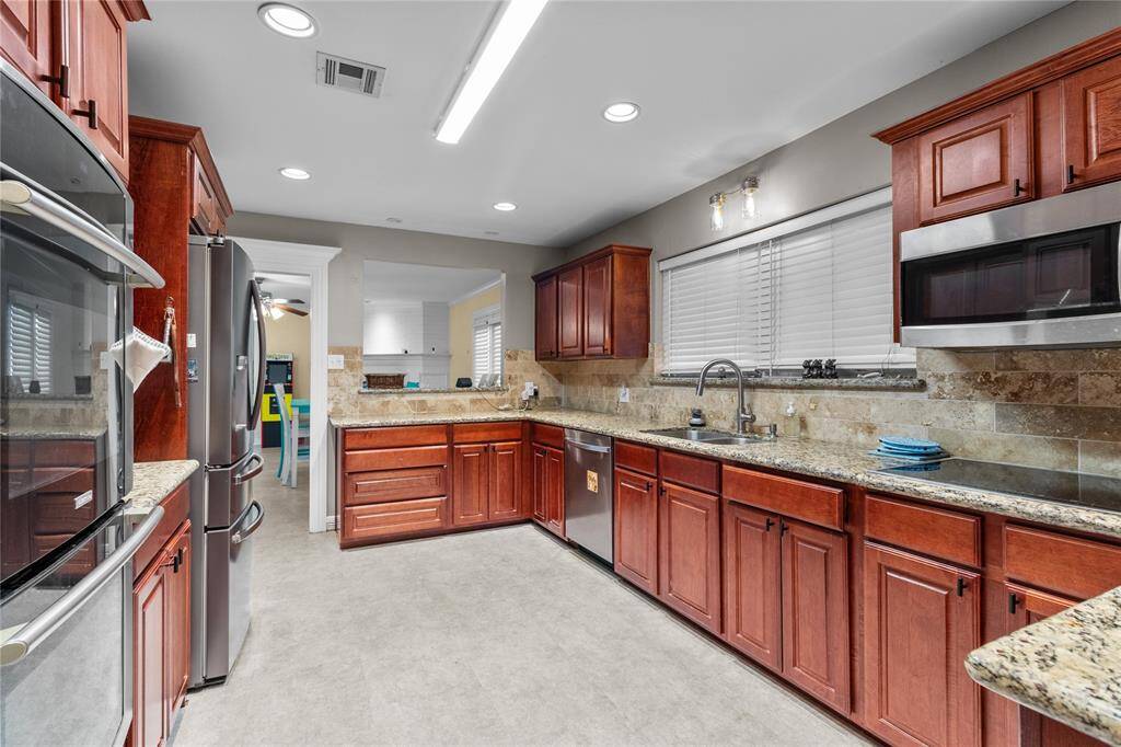Gorgeous kitchen with abundance of cabinetry double oven, dishwasher, microwave and cook top stove. Refrigerator not included.