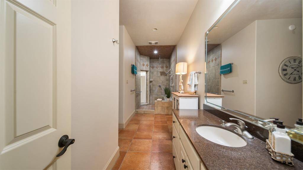 Another vanity with third sink and mirror on the separate side of the primary bath.
