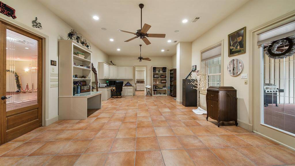 Large office/foyer area of the home with lots of storage and built-ins.