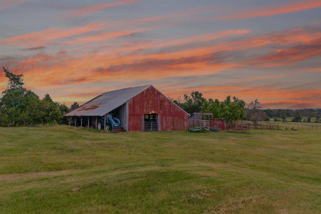 Nothing says Texas more than a tractor, red barn and a sunset.
