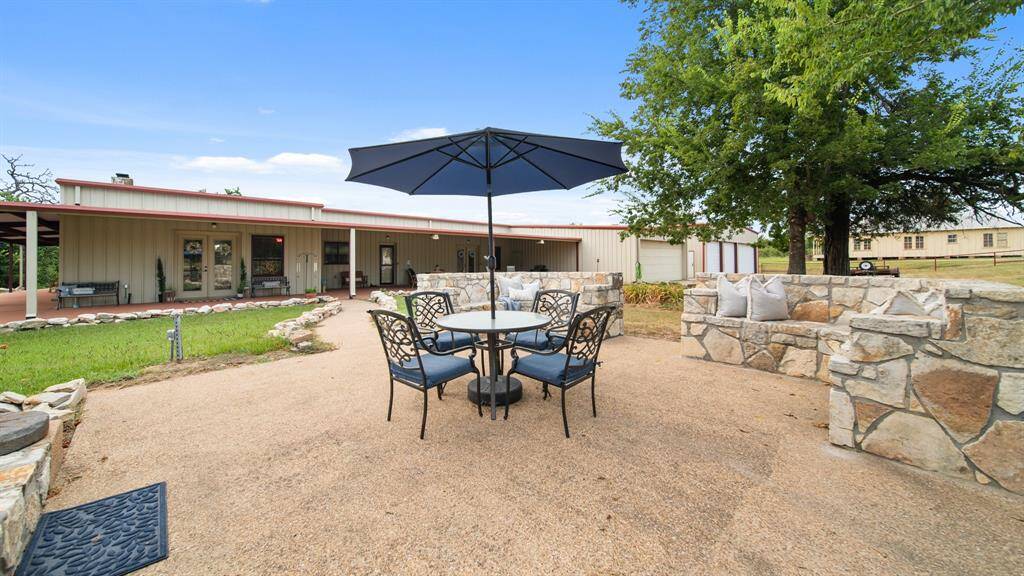 Enjoy incredible evening sunsets from your large outdoor patio complete with custom stone seating area.