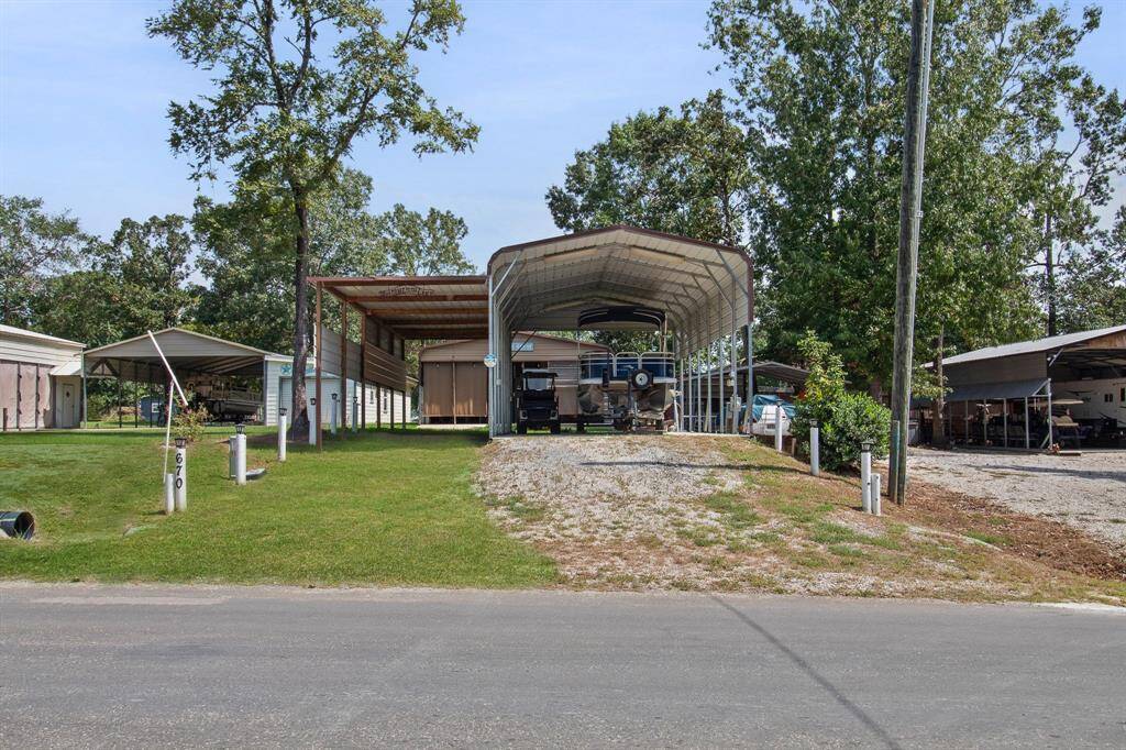 Spacious 18' x 36' RV/Boat parking space, equipped with a 30amp electrical connection, a sewer cleanout hookup, and a freshwater supply.