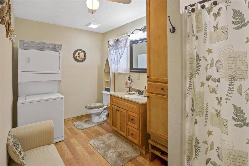 Discover the convenience of a well-appointed bathroom, complete with laundry facilities and a walk-in shower.