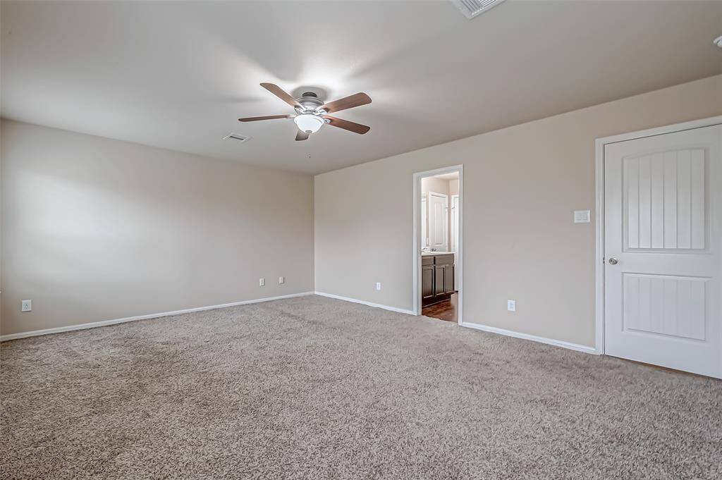 The ensuite primary bedroom offers a private retreat, complete with a spacious layout and luxurious features. Its attached bathroom provides a serene space for relaxation, enhancing the overall comfort and convenience of the room.