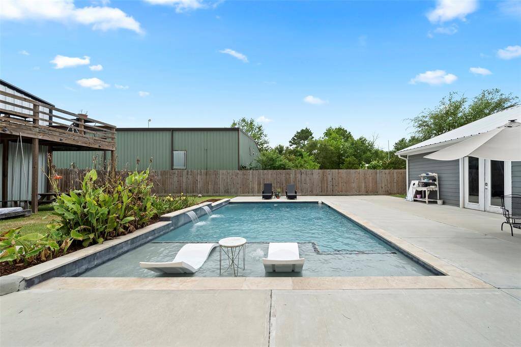 Relaxing pool with pebble tech and waterfall.