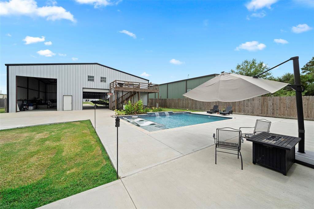 Just past the pool is a large airplane hanger with a secondary suite and large balcony!