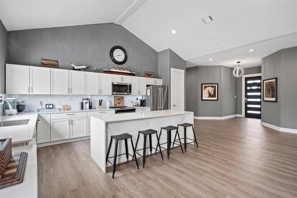 High Ceilings and Beautiful Wood Flooring!
