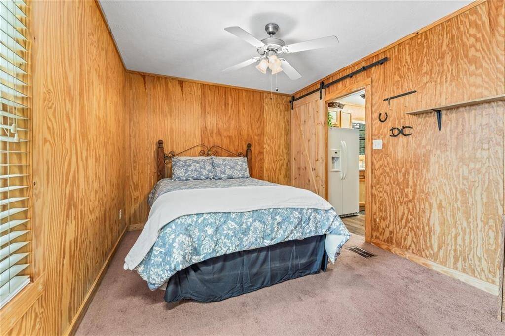 Downstairs bedroom near kitchen with large closet opposite of bed.