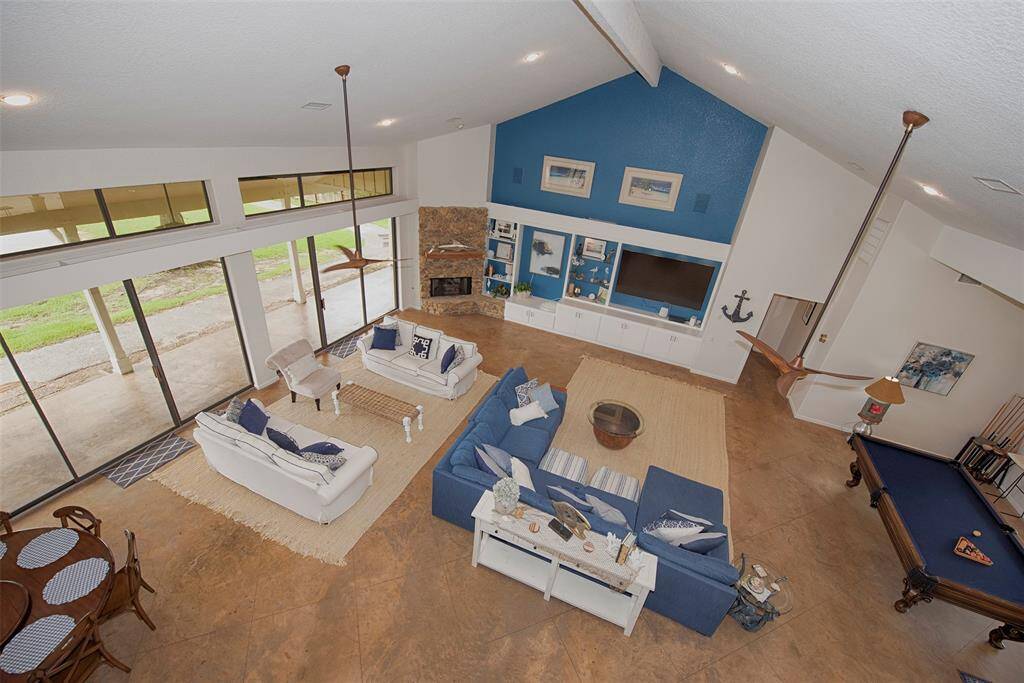 At the top of the stairs and aerial view of the fabulous family room. Upstairs lofted room is open to the lower living/ entertaining area so everyone always feels together.