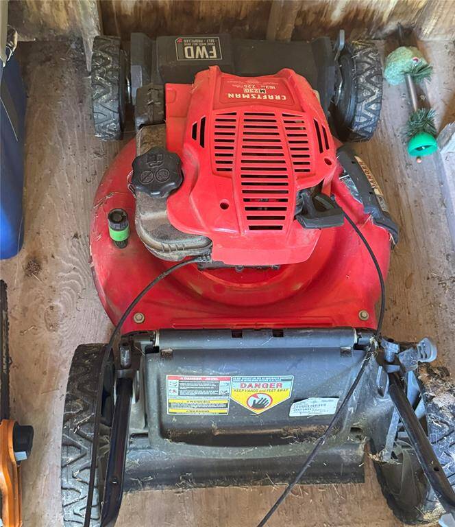 A convenient push mower stored in the compact shed.