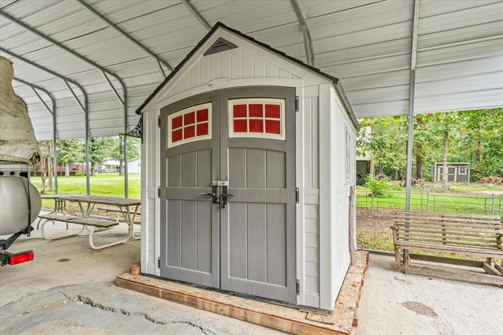 Storage building for yard tools and fishing poles.