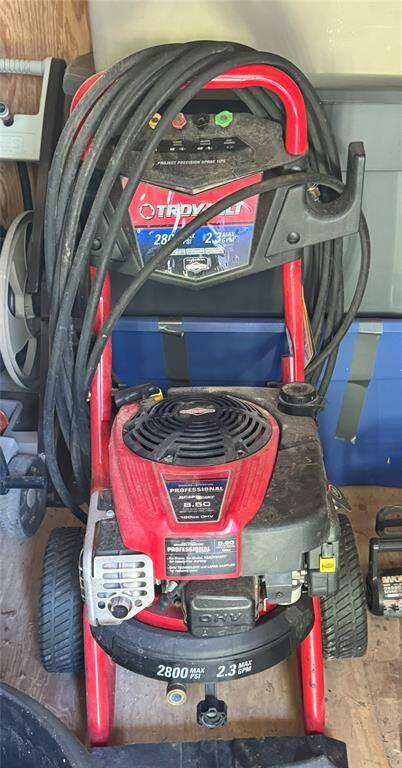The home includes a convenient pressure washer stored in the small shed.