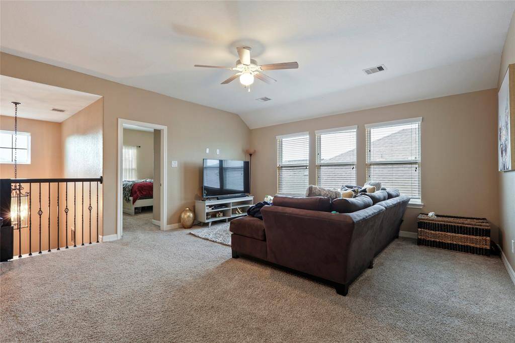 Cozy second living area, with tons of space and lighting. Perfect for a pool table or playroom.
