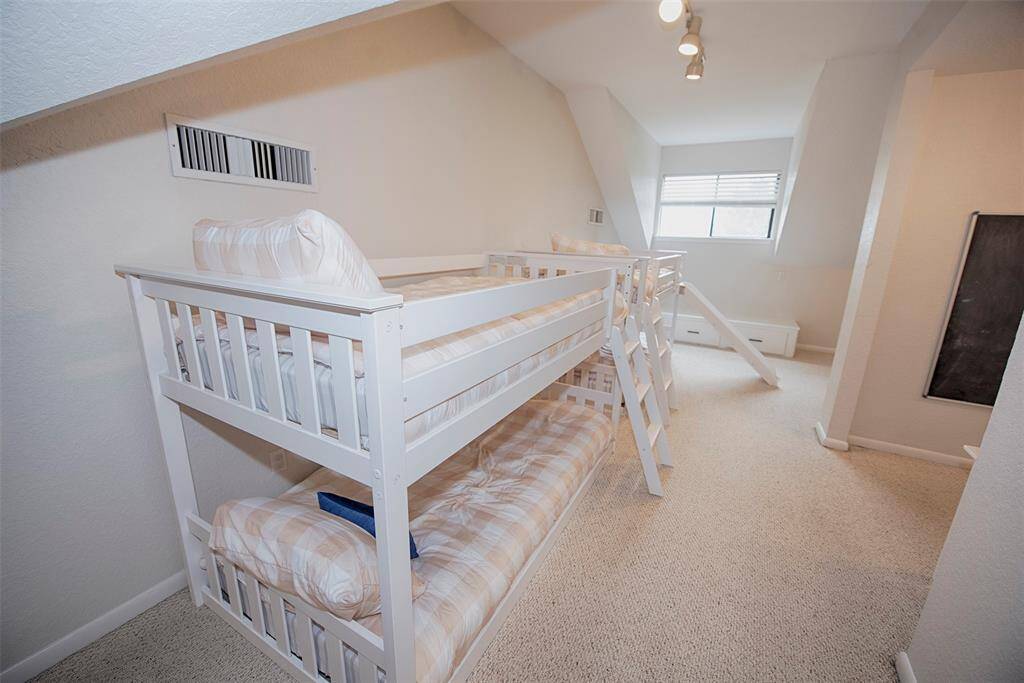 Upstairs lofted room features two double bunk beds.