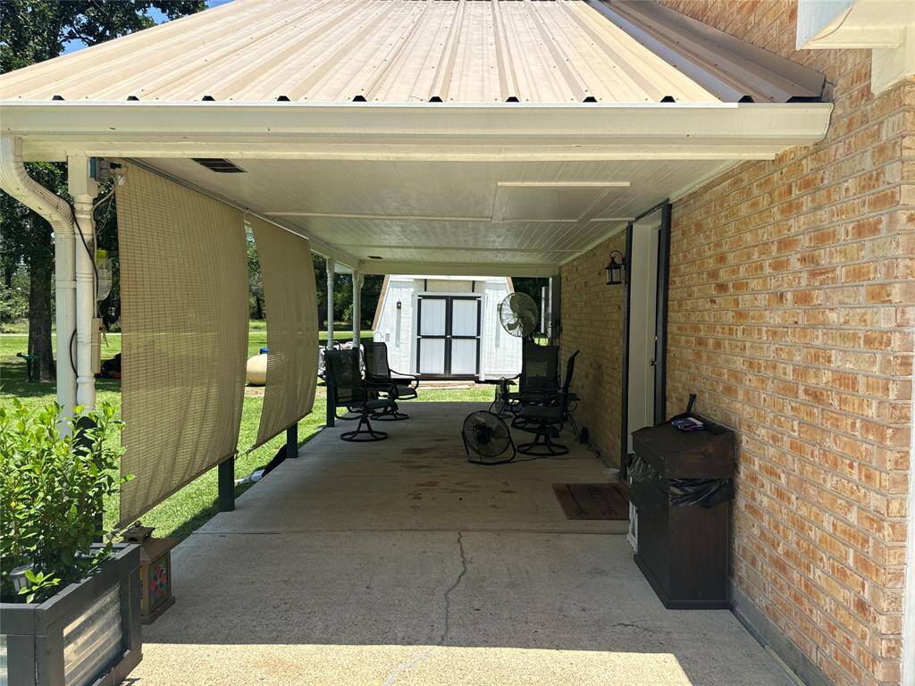 Spacious carport with convenient access to the converted garage, offering versatile use options.