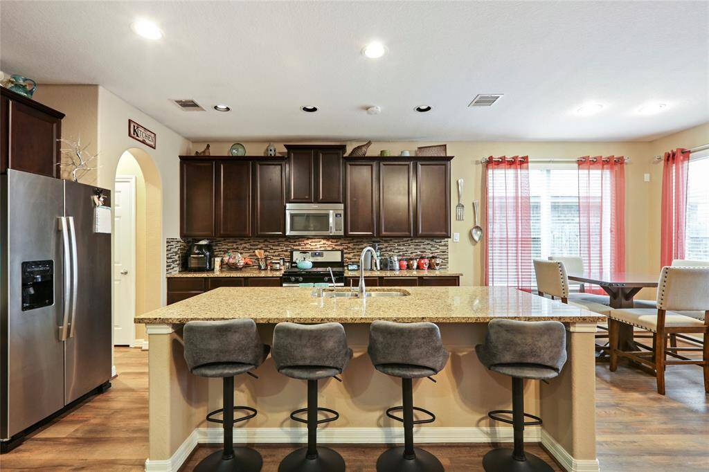 Beautiful granite countertops with stainless steel appliances.
