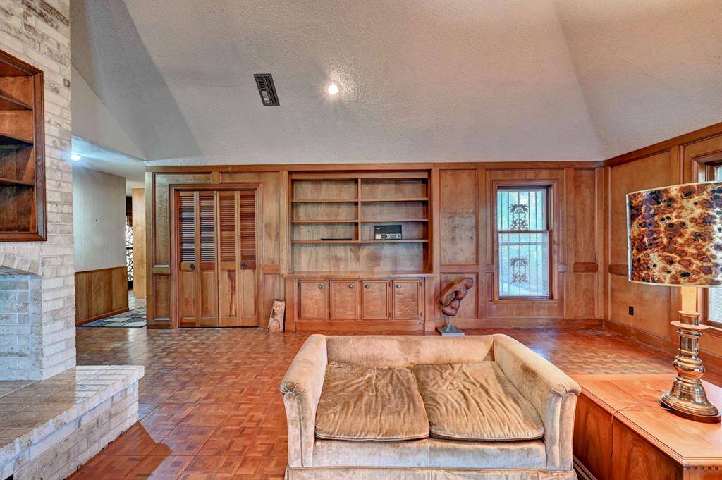 Beautiful mill work in these built ins. Open the sliding doors to your private wet bar!