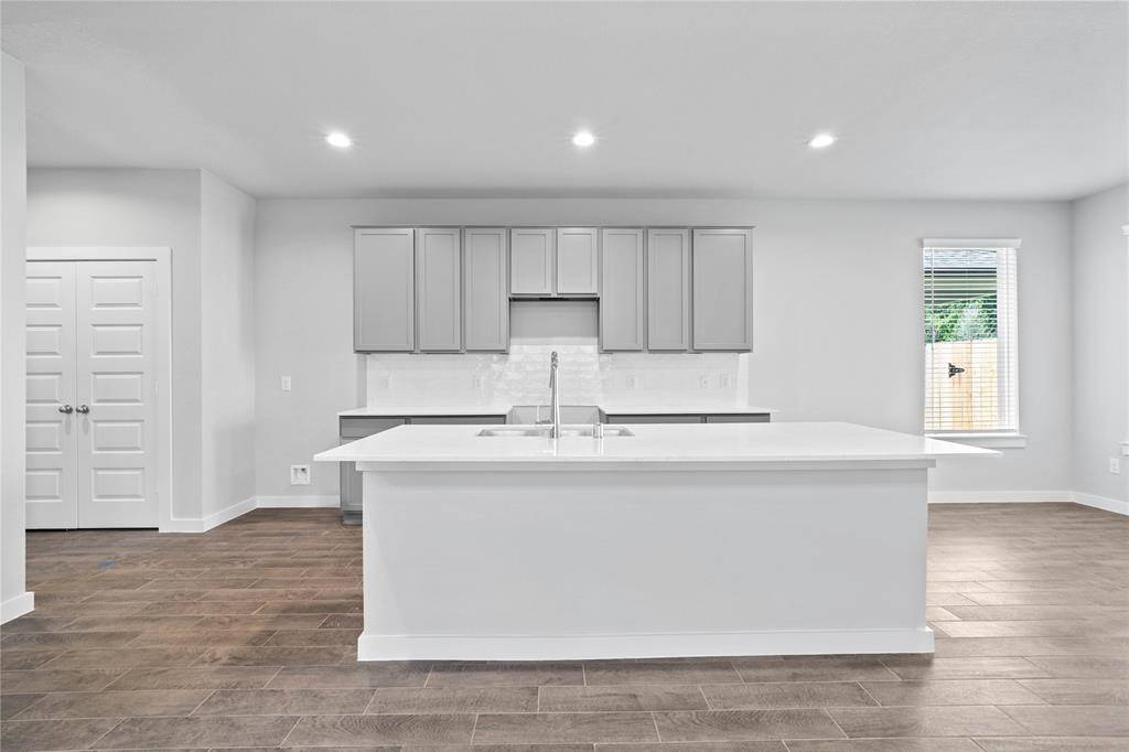 Additional view of this spacious kitchen and the large kitchen island.